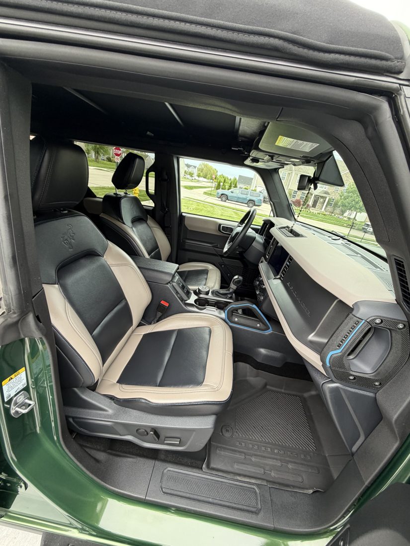 Detailed front seats of a Ford Bronco, two-tone leather cleaned and conditioned